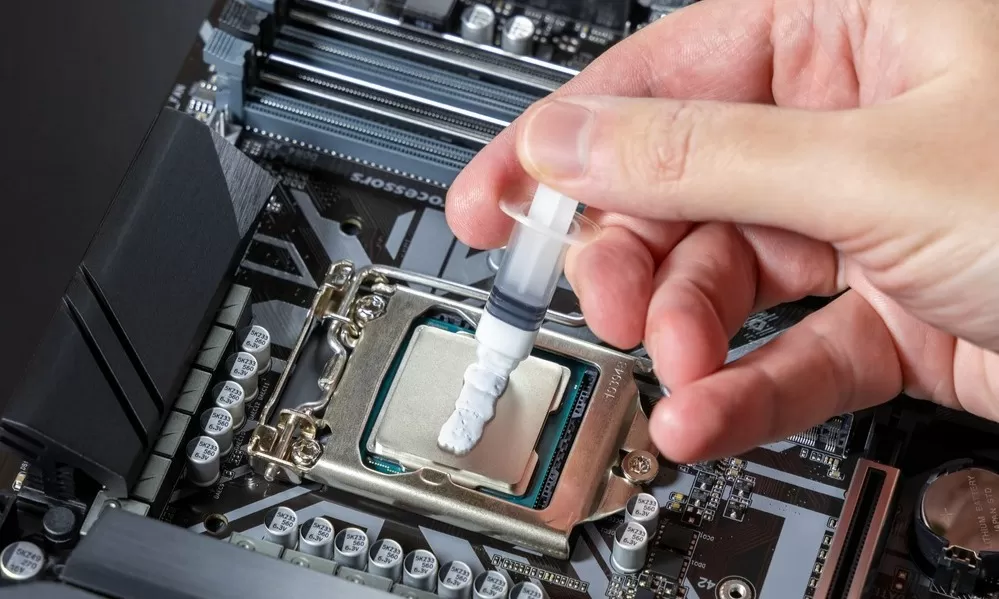 Technician Applies White Thermal Paste to the CPU