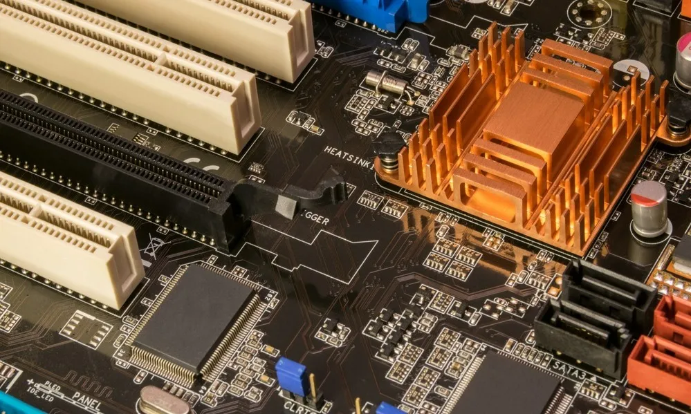 An electronic board showcasing various components, sockets, and heat sinks, highlighting the complexity and intricacy of modern electronic design.